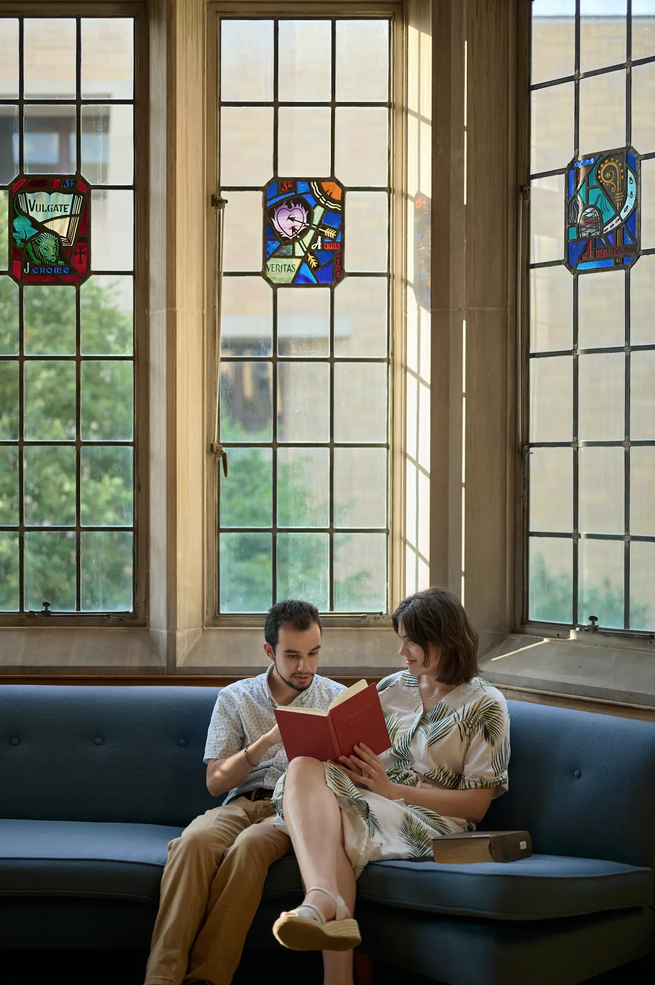 A couple reads together in the library at Saint Thomas University